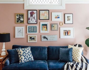 Light pink living room with blue velvet sofa