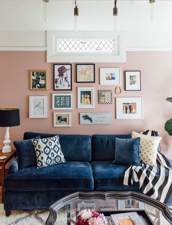 Light pink living room with blue velvet sofa